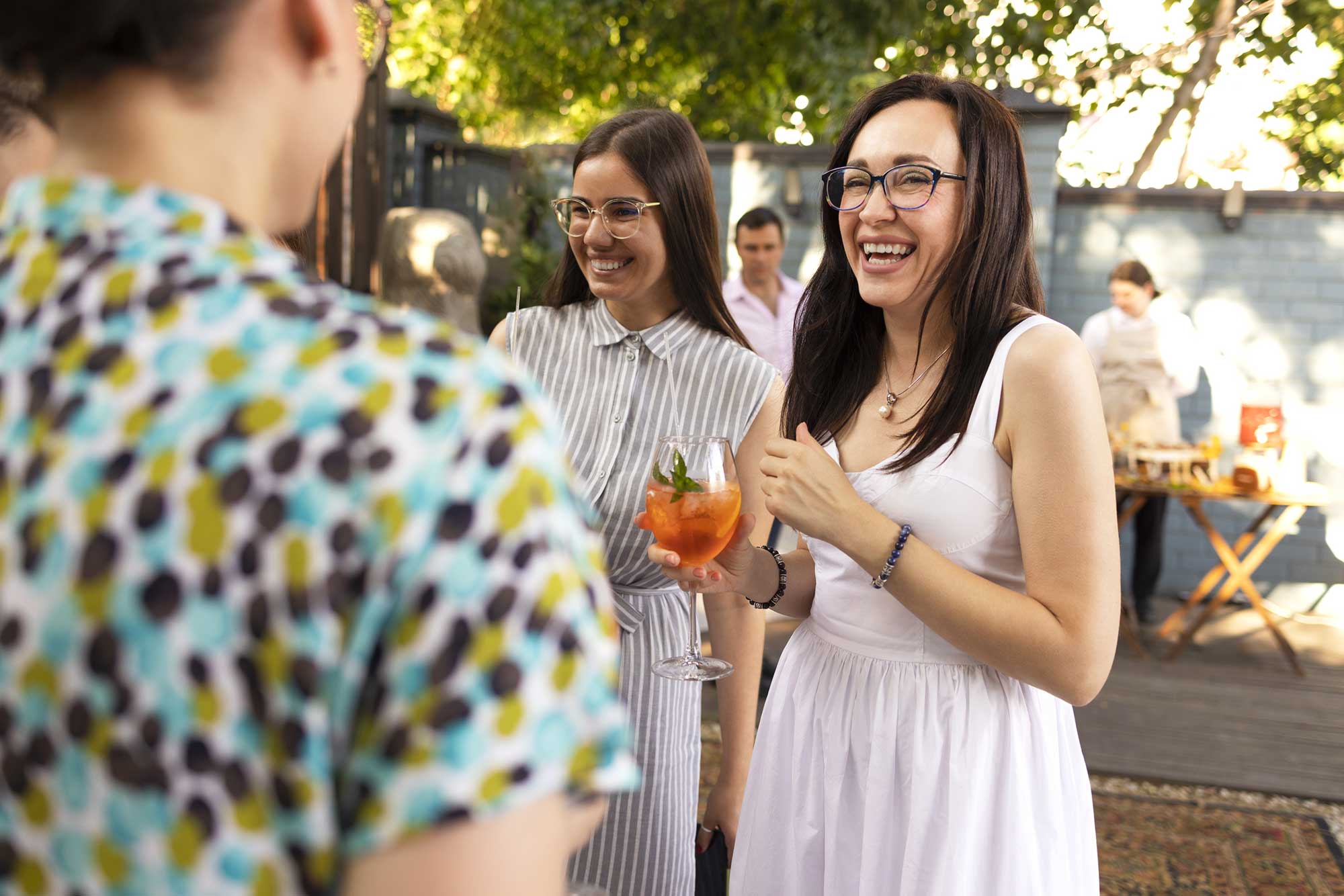 Guests enjoying drinks served by mobile bartenders at a party.