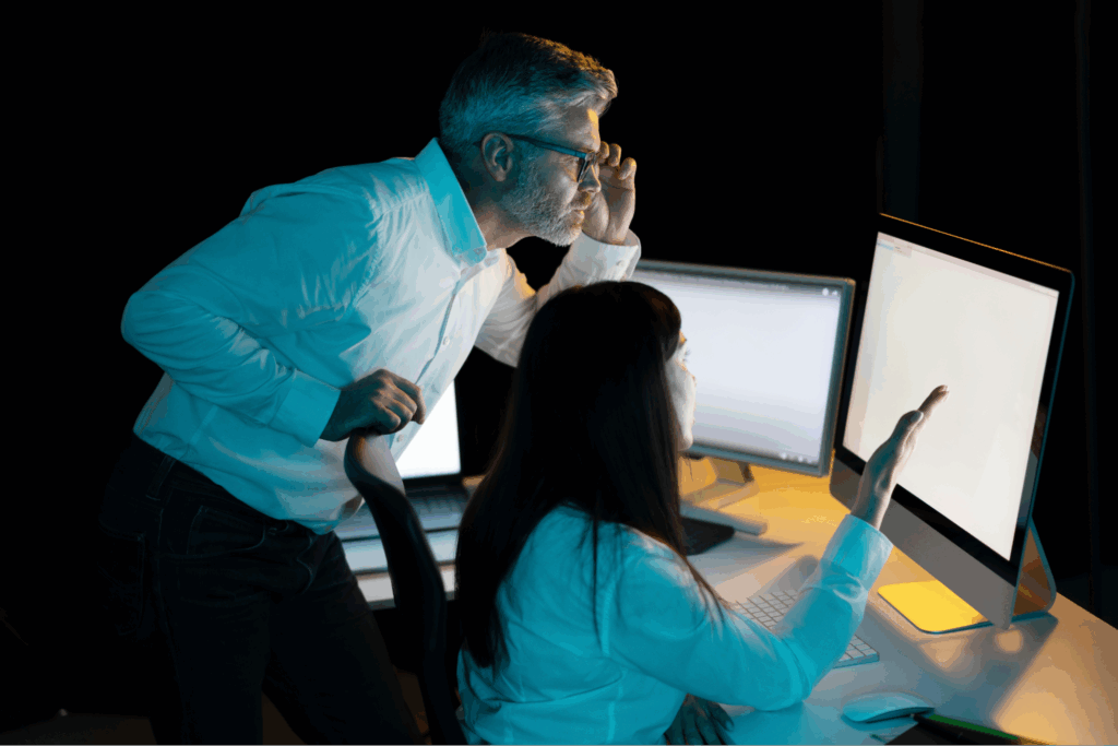 A man and a woman looking at a computer screen.