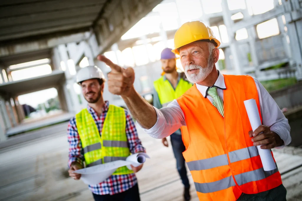  General contractor overseeing construction progress and coordinating tasks with crew.