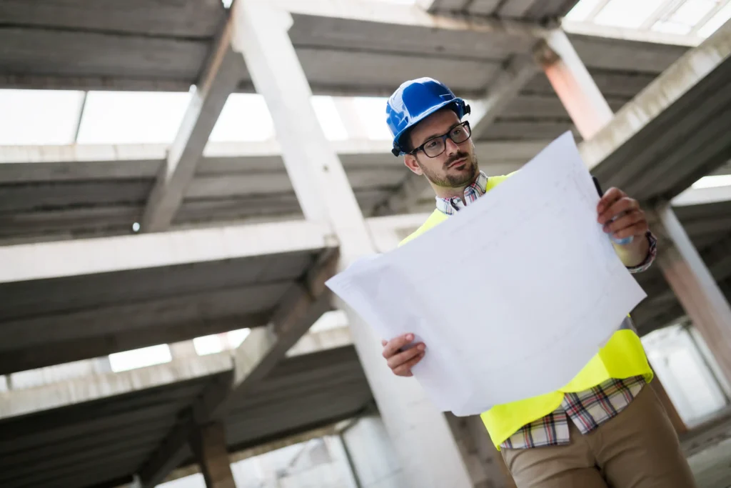General contractor reviewing blueprints on a construction site.
