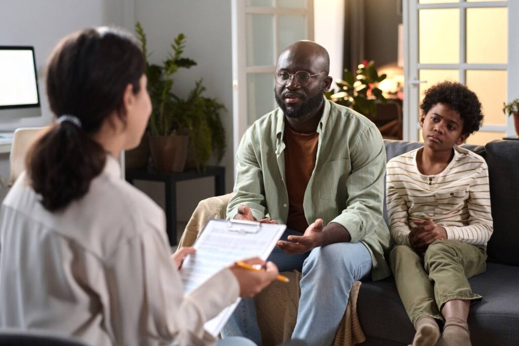 A father and son participating in therapy