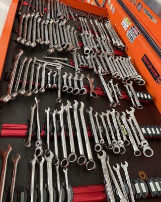 A large assortment of wrenches and tools neatly arranged in a toolbox, showcasing various sizes and types.