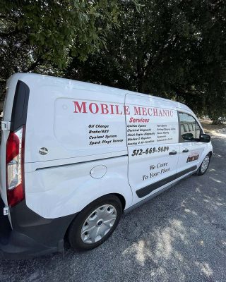 Mobile mechanics working on vehicles in Houston, Texas, providing on-site automotive repair services.