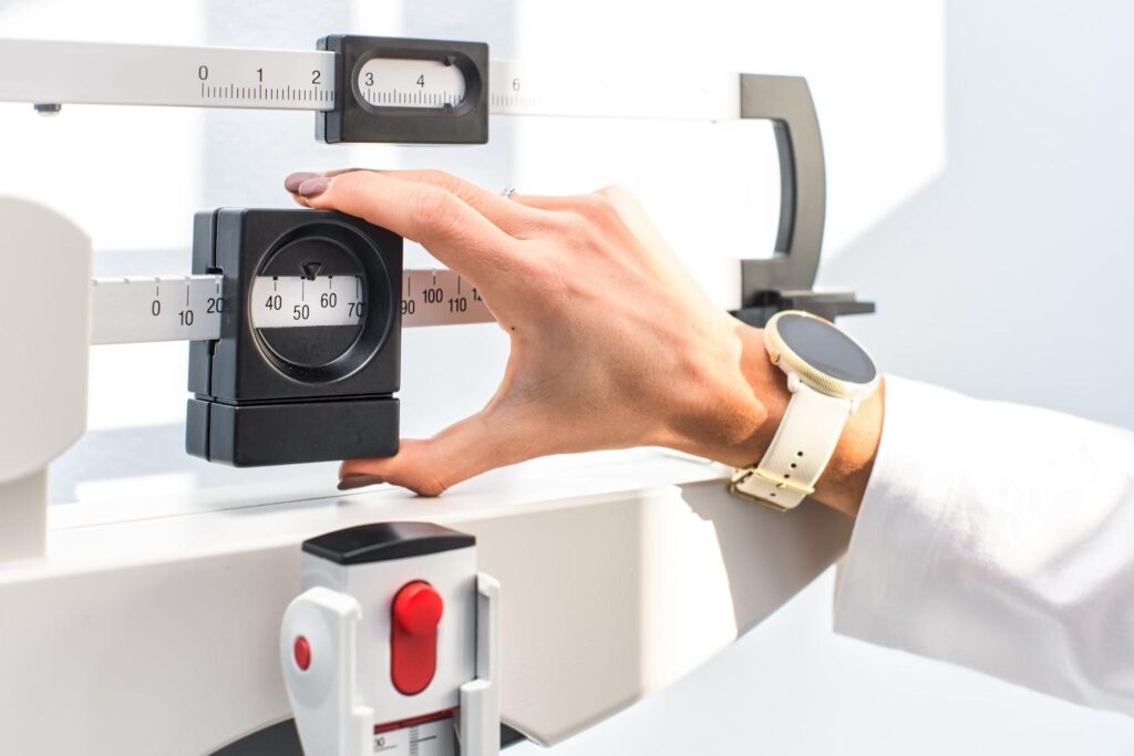 Doctor adjusting a scale.
