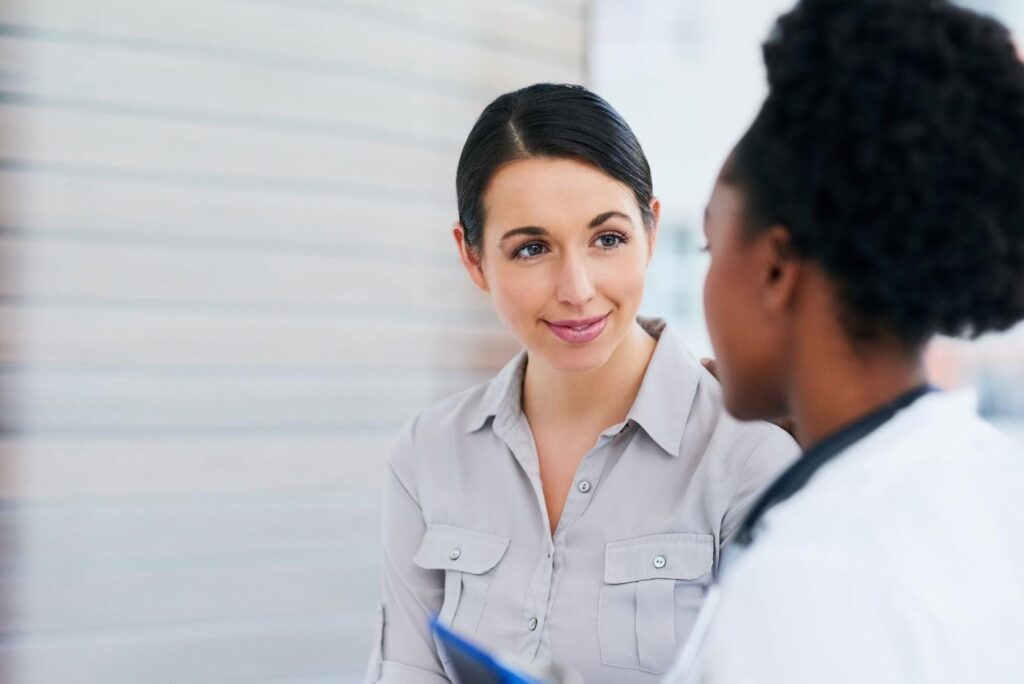 Woman speaking to a female doctor.