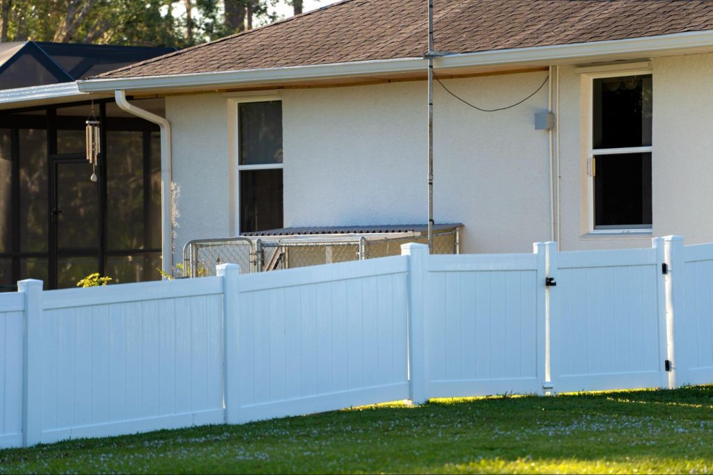 Vinyl fence gate around a home.