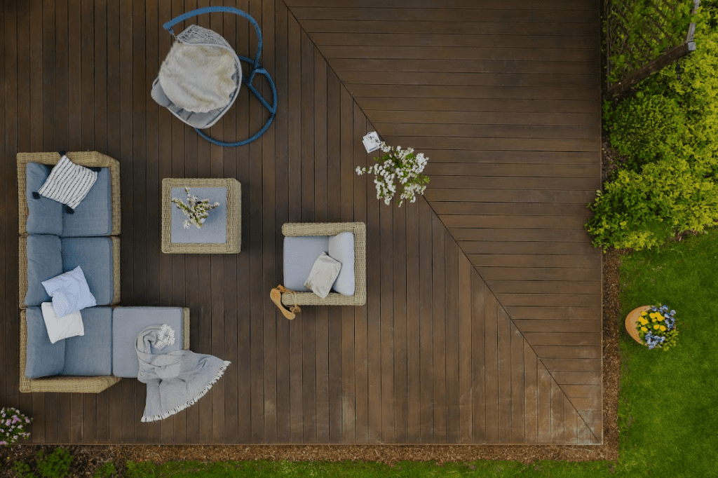 An overview of a wooden deck with outdoor furniture.