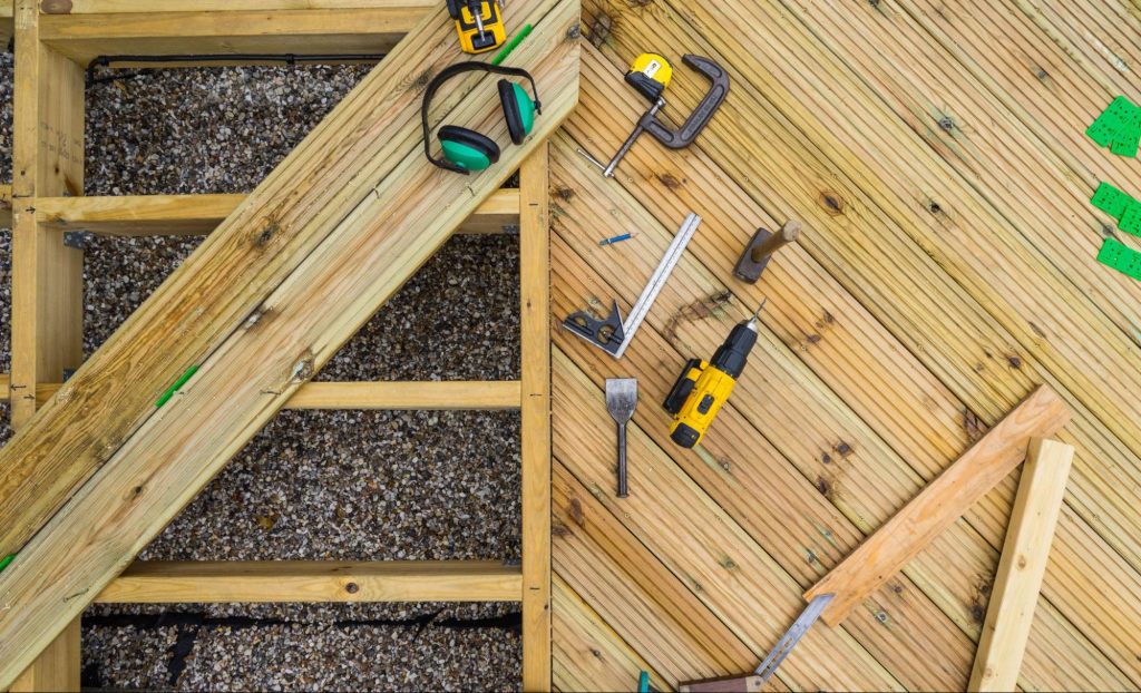 Top view of deck building tools and a partially constructed deck in progress.