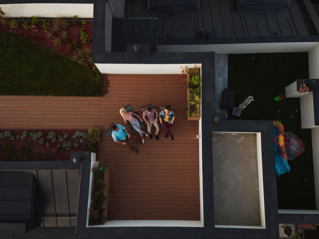 Overhead view of a deck with friends sitting in chairs.