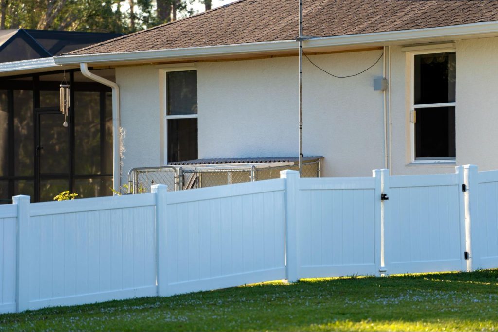 A white vinyl fence encloses the property to deter trespassers.