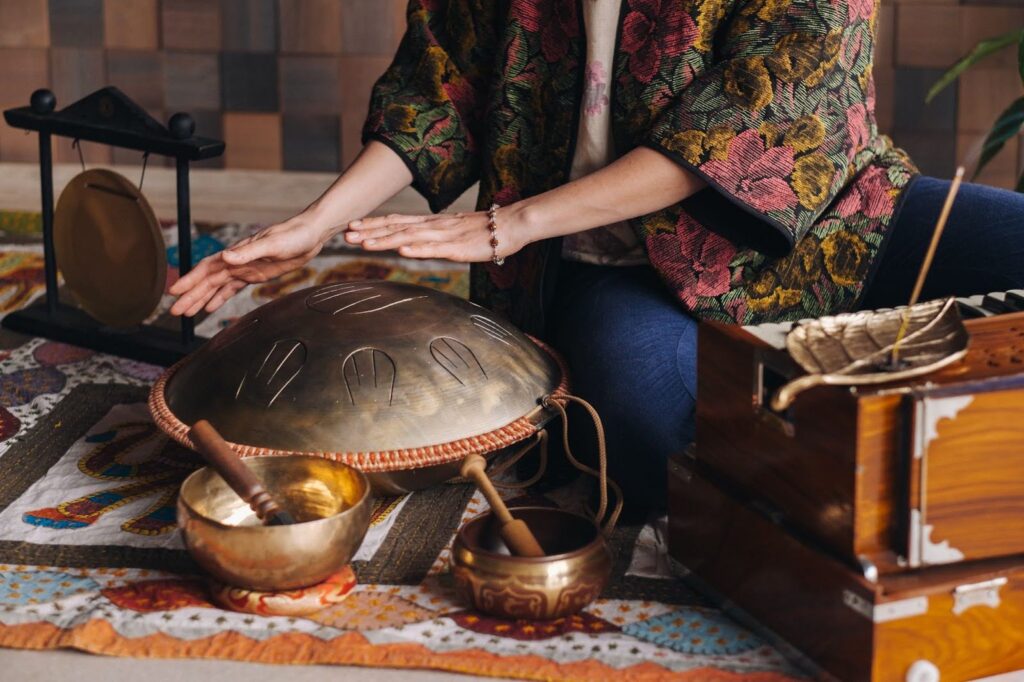 Close-up of a woman playing an Orion reed drum.