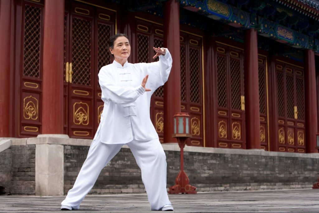 A senior woman practicing Tai Chi at the Temple of Heaven.